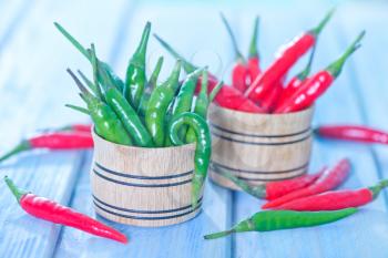 green and red chilli peppers on a table
