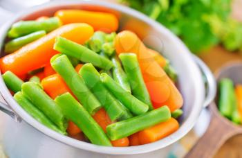 carrot and green beans in the metal bowl