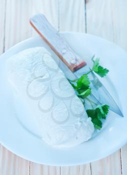 mozzarella on white plate and on a table