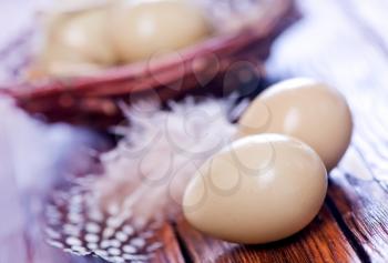 Eggs pheasant and nest on the wooden table