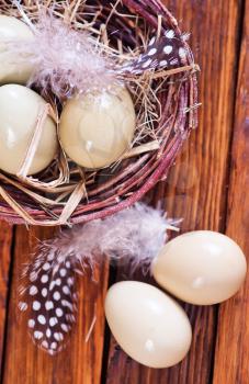 Eggs pheasant and nest on the wooden table