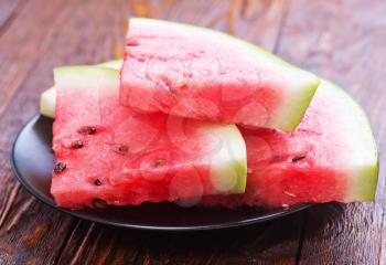 fresh watermelon on plate and on a table