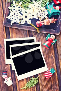 Vintage photo frames decorated for Christmas on the wooden board 