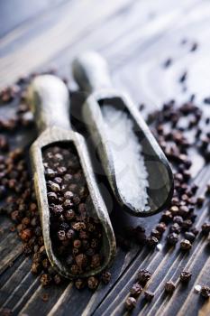 black pepper and white salt on  a table