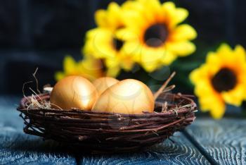golden eggs, easter eggs on a table