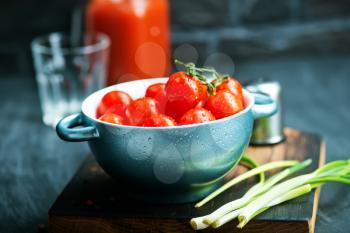 fresh tomato in bowl and on a table