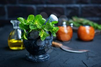 fresh mint in bowl, aroma herb on kitchen table