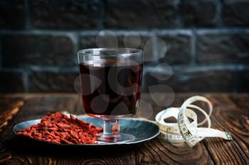 drink from goji and dry goji on a table