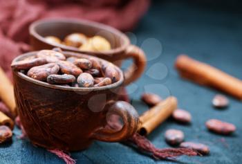 cocoa beans in cup and on a table