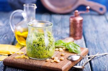 pesto sauce in glass and on a table