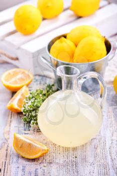 fresh lemon drink in glass jug and on a table