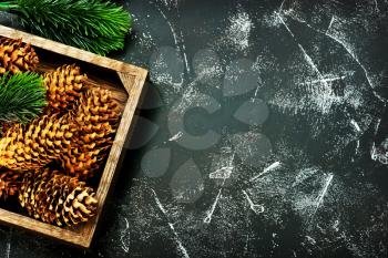 christmas decoration, cones and branch on a table