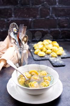 Boiled dumplings in bowl and on a table