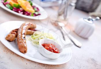 fried sausages with sauce on the plate