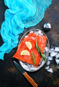 raw salmon with salt and lemon on a table