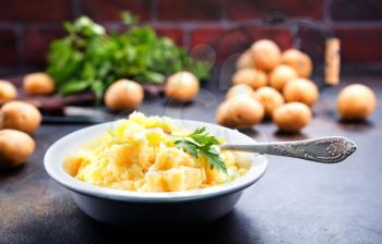 portion of mashed potatoes with butter on a plate