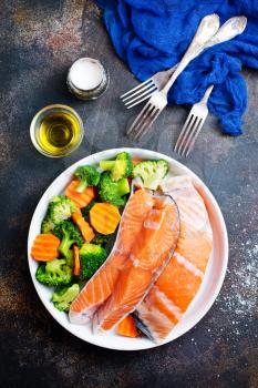 salmon with vegetable salad on white plate