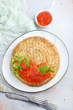 pancakes with red salmon caviar, fried pancakes