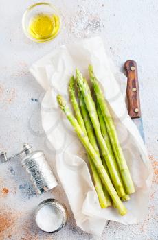 green asparagus on paper on a table
