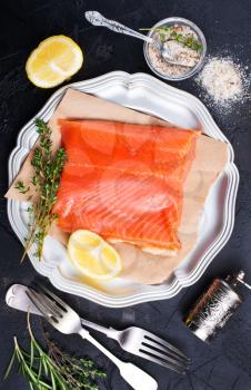 salmon fish on plate with lemon and salt