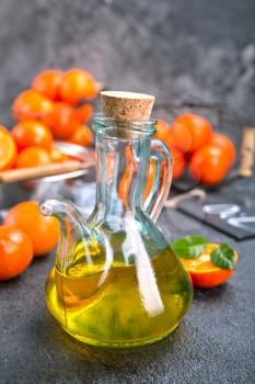 tangerine oil, fresh tangerines and oil in glass 