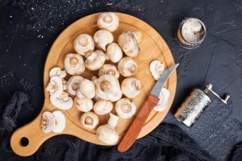 raw mushrooms on wooden board, Champignon mushrooms