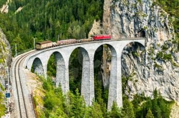 Freight train crossing the Landwasser Viaduct in the Swiss Alps