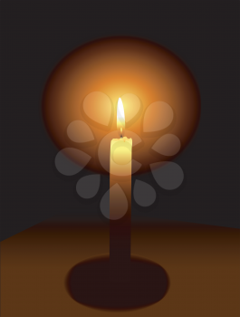 The big burning candle on a dark background