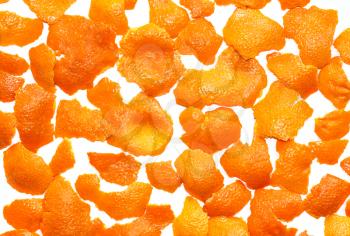 Tangerine pelts scattered on a white background