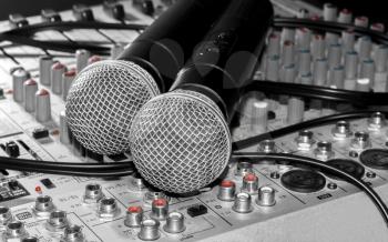 Wireless microphones and a mixer close up