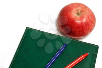 Red apple diary and pen isolated on white background
