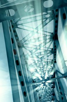 Railway metal bridge perspective view. Ray lights glowing. Monochrome image
