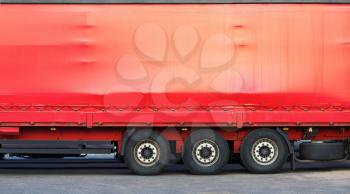 Close-up of the side of a big red truck. Space for text or image.