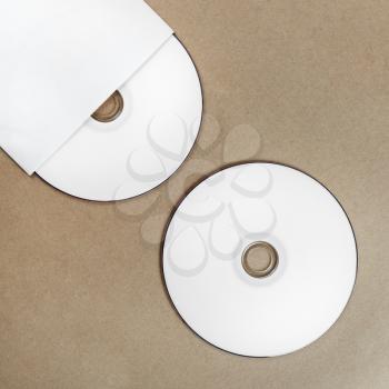 Photo of blank compact disk on a table. Template for branding identity for designers. Top view.