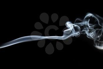 Photo of abstract smoke swirls on black background.