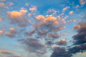 Dramatic sunset sky with cumulus clouds. Blurred cloudy background.