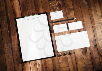 Blank stationery set on wooden table background. ID template. Mock up for branding identity for design presentations and portfolios. Top view.