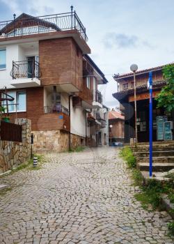 Sozopol, Bulgaria - September 06, 2014: Old town of Sozopol at Black Sea, Bulgaria. Street, ancient architecture and cobbled stone pavement. Architectural and Historic Complex. Vertical shot.