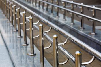 Chromium metal fence with handrail. Chromium metal railings. Shallow depth of field. Selective focus.
