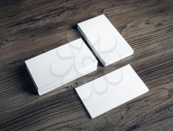 Photo of blank white business cards on vintage wooden table background. Mock up for ID. Blank template for branding identity.