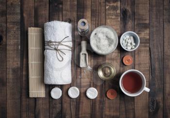Composition of spa. Wellness cosmetic products on vintage wood table background. Flat lay.