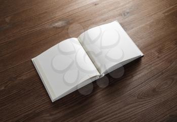 Blank open book on wooden background. Mock-up for graphic designers portfolios. Responsive design mockup.