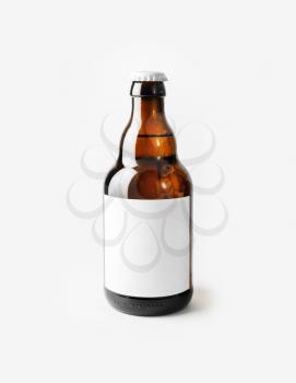 Brown beer bottle with blank label. Responsive design mockup.