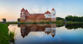 Mir, Belarus - August 11, 2016: Castle and lake. Medieval fortress in Mir, Belarus. Ancient castle with towers. UNESCO World Heritage. Panoramic view