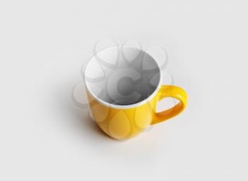 Yellow ceramic cup or mug for coffee or tea.