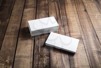 White paper business cards on wood background. Mockup for branding identity. Blank template for your design.
