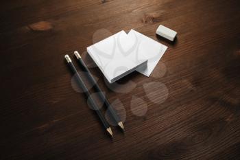 Blank stationery template for placing your design. Blank notes, pencils and eraser on wooden background. Mockup for branding identity.