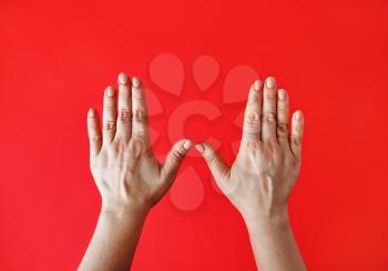 Female hands on red background. Women's palms.