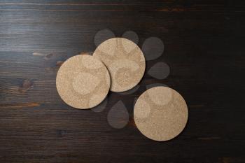 Blank cork beer coasters on wooden background. Responsive design template. Top view. Flat lay.
