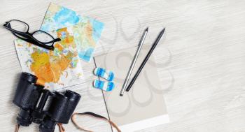 Travel concept background. Traveler accessories and items on light wood table. Top view. Flat lay.